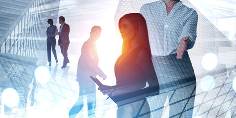 Silhouettes of business people overlaid with modern glass architecture, light flares and reflections, on a bright background, symbolizing teamwork and innovation
