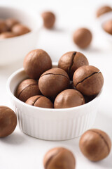 Fresh organic macadamia nuts on white background