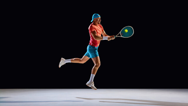 Male tennis player jumping for midair shot with precision and intensity. Concept of science visuals, biomechanics of movement, muscle coordination, and kinetic research imagery.