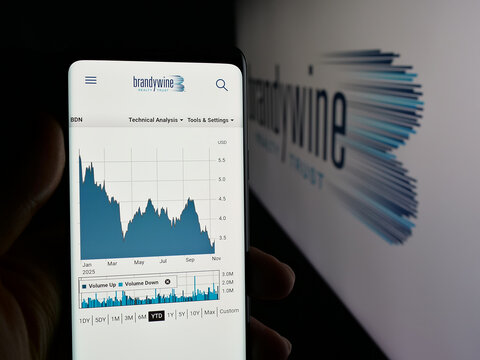 Stuttgart, Germany - 11-13-2025: Person holding cellphone with webpage of real estate company Brandywine Realty Trust on screen in front of logo. Focus on center of phone display.