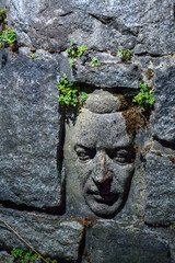 stone head on the bank of the Vltava River
