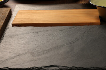 Dark black slate stone marble board wooden chopping bard copy text space frame background