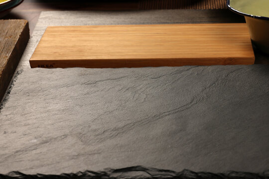 Dark black slate stone marble board wooden chopping bard copy text space frame background
