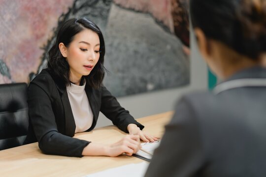 Professional woman intensely focused on reading and reviewing critical documents during financial due diligence and strategic assessment