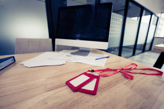 Corporate security identification badges on wooden desk near doc
