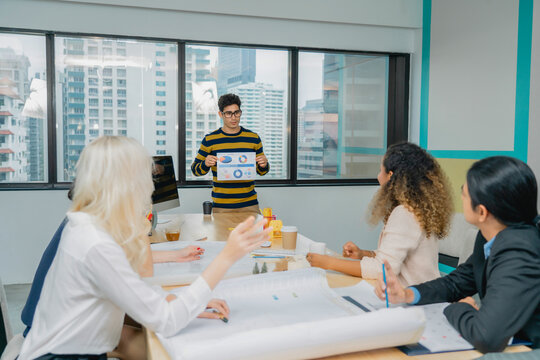 Diverse group business presentation in office. Data-driven decis