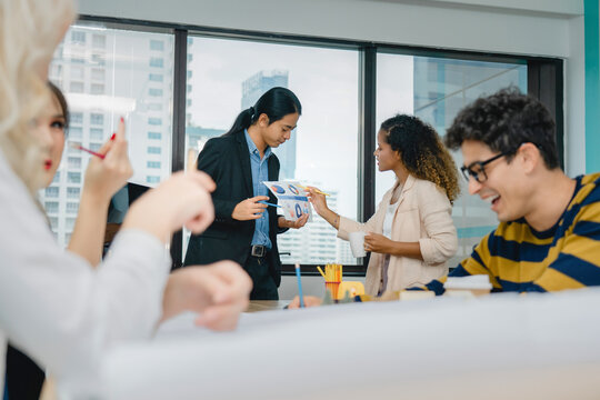 Diverse corporate professionals engage in close consultation, re