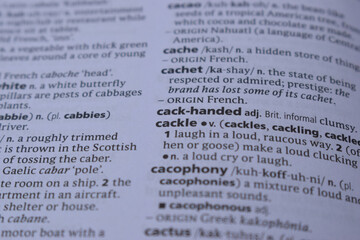 Fototapeta premium English Dictionary Page Close Up With The Word Meaning Of -cackle