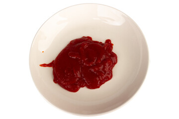 Ketchup splashing on a white plate on white background