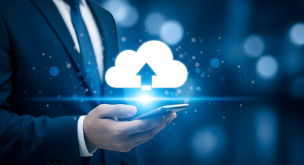 Businessman using a smartphone for cloud data upload showcasing modern technology and digital connectivity in a corporate setting with a sleek blue background and professional attire