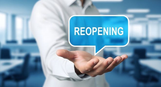 Man presents reopening message in a speech bubble symbolizing business recovery and economic restart after crisis in a modern office environment with desks and chairs visible