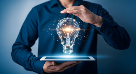 Man presents a glowing lightbulb concept on a tablet symbolizing innovation and creative solutions for business and technology advancements in a modern digital world