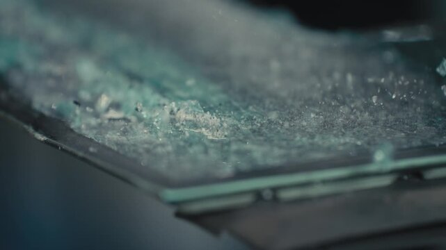 Broken Glass Vibrating on Edge of Pane During Impact