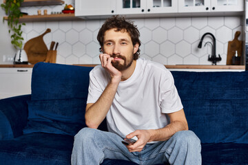 Relaxing in a cozy home, a young man enjoys a quiet evening on the couch