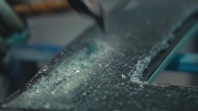Hammer Breaking Safety Glass in Workshop Close Up