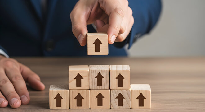 Man stacking wooden blocks with upward arrows representing growth and success in business strategy and career development on a wooden table symbolizing progress and achievement
