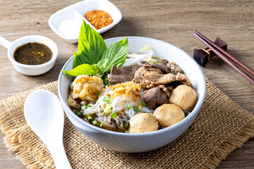 Boat noodles on a wooden table