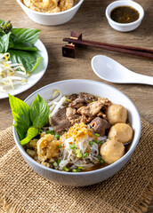 Boat noodles on a wooden table
