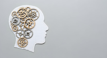 Paper cutout of human head with gears inside symbolizing thinking process and brain function