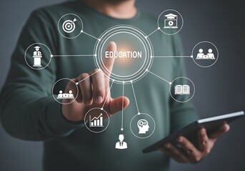 Man touching education graphic with icons on tablet, representing online learning and development tools