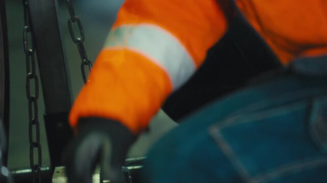 Mechanic Tightening Bolt with Hand Tool in Workshop