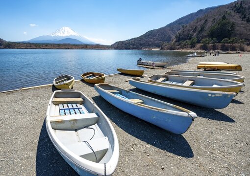 Rowing boats on shore, view across the lake to Mt Fuji volcano, Motosu Lake, Yamanashi Prefecture, Japan