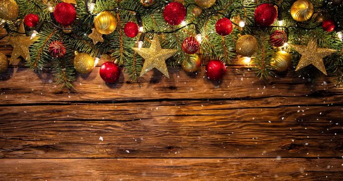 Cozy Christmas decorations arranged on rustic wood with gentle falling snow creating a festive winter atmosphere. Ideal as a holiday background or seasonal backdrop.