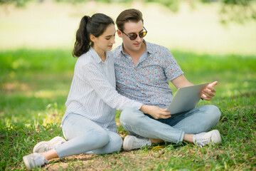 Couple intensely focused on laptop screen; digital data analysis, collaborative problem-solving,...