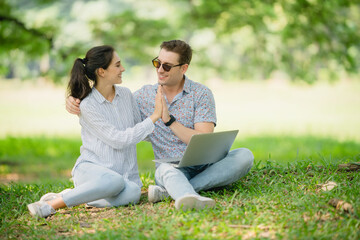Couple celebrating successful agreement with a high-five; digital milestone achievement, collaboration, partnership success, teamwork win.