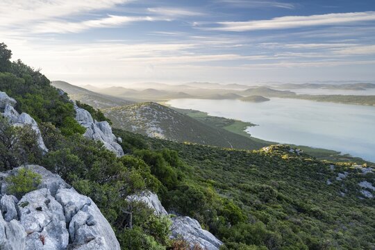 View of Vrana Lake and the coast with islands behind it, Vransko Lake nature park Park, Dalmatia, Croatia