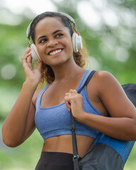 Woman standing outdoors with arms open wide, deep breath, personal freedom, stress relief, and mental wellness in nature