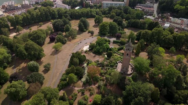 Bristol UK: 28th July 2025: Breathtaking drone view of Cabot Tower surrounded by lush greenery of Brandon Hill park with city in background