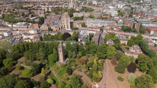 Bristol UK: 28th July 2025: Breathtaking drone view of Cabot Tower surrounded by lush greenery of Brandon Hill park. With University of Law in background