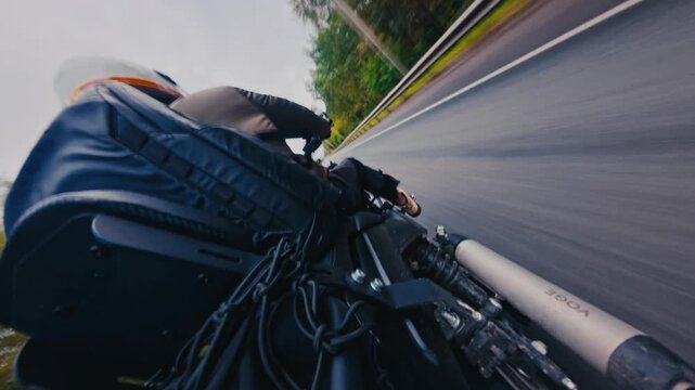 First-person motorcycle riding view on countryside road at sunset with dashboard