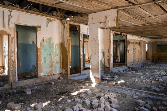 Destroyed abandoned classroom of the old school, wall painting with Soviet miners, ghost town, Engilchek, Tian Shan, Kyrgyzstan