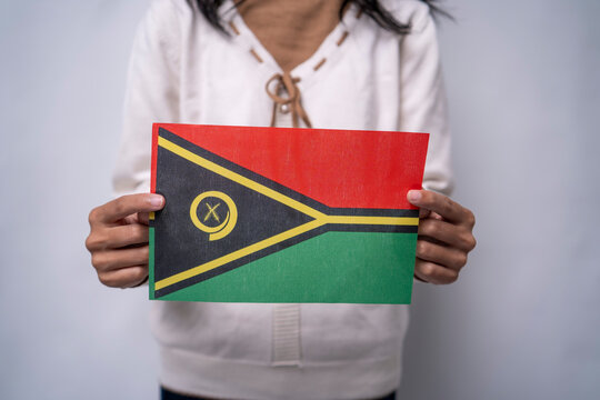 Person Holding Vanuatu National Flag Against Neutral Background - Powered by Adobe