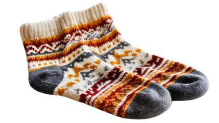 A pair of knitted wool socks with a Christmas pattern isolated on a white background, warm winter clothing accessories, a traditional Nordic style, soft cozy foot wear object.
