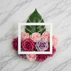 Minimalist white frame with roses and green leaf on a marble table