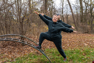 Two Women Stretching Outdoor. Sport fitness for elderly woman in nature. Personal trainer for seniors