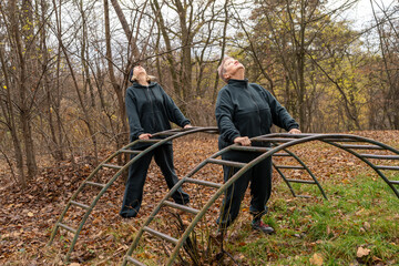 Two Women Stretching sport in park. Exercising for senior elderly woman with trainer