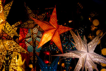 Christmas decoration with ornaments lights fir branches golden baubles red ribbons and festive details creating holiday atmosphere indoor seasonal design bright colorful winter celebration style scene