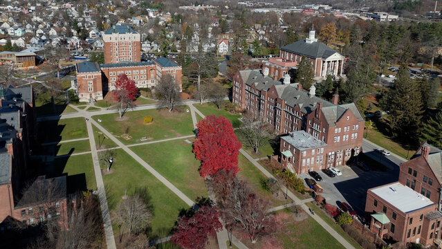 Aerial view of the Vassar College campus with its historic brick buildings, open green spaces, and vibrant fall foliage creating a tapestry of warm hues, Poughkeepsie, New York, United States.