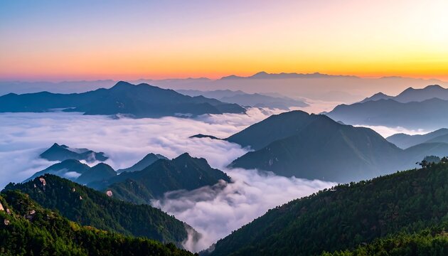 Mountain peaks pierce a sea of mist under a vibrant sunrise sky, verdant slopes leading to misty horizons