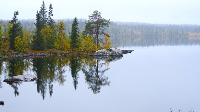 idyllic lake in Scandinavia with reflecting trees in the water 322 
