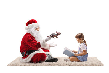 Santa Claus holding a dinosaur toy and girl reading a story