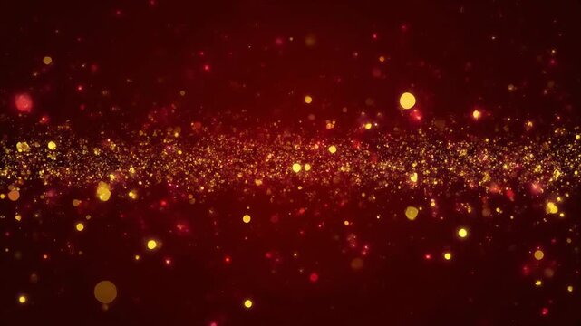 Abstract red background with golden glitter particles floating.