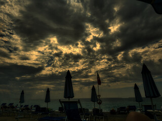 Beach with umbrellas at dawn in Spotorno on the Ligurian Riviera during the summer