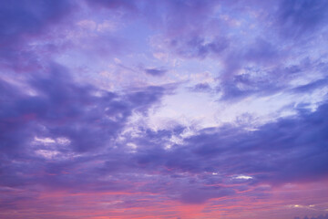 Purple clouds and sky,A beautiful sunset sunrise blue sky with a few clouds and a pinkish tint. The sky is calm and peaceful and the clouds add a sense of depth and texture to the scene.