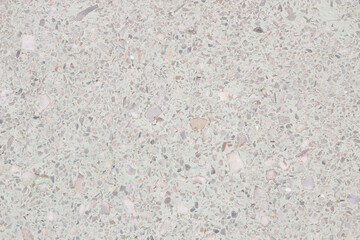 A used white terrazzo floor that looks a bit dirty.
