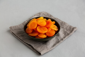 Organic Raw Dry Apricots in a Bowl, side view.